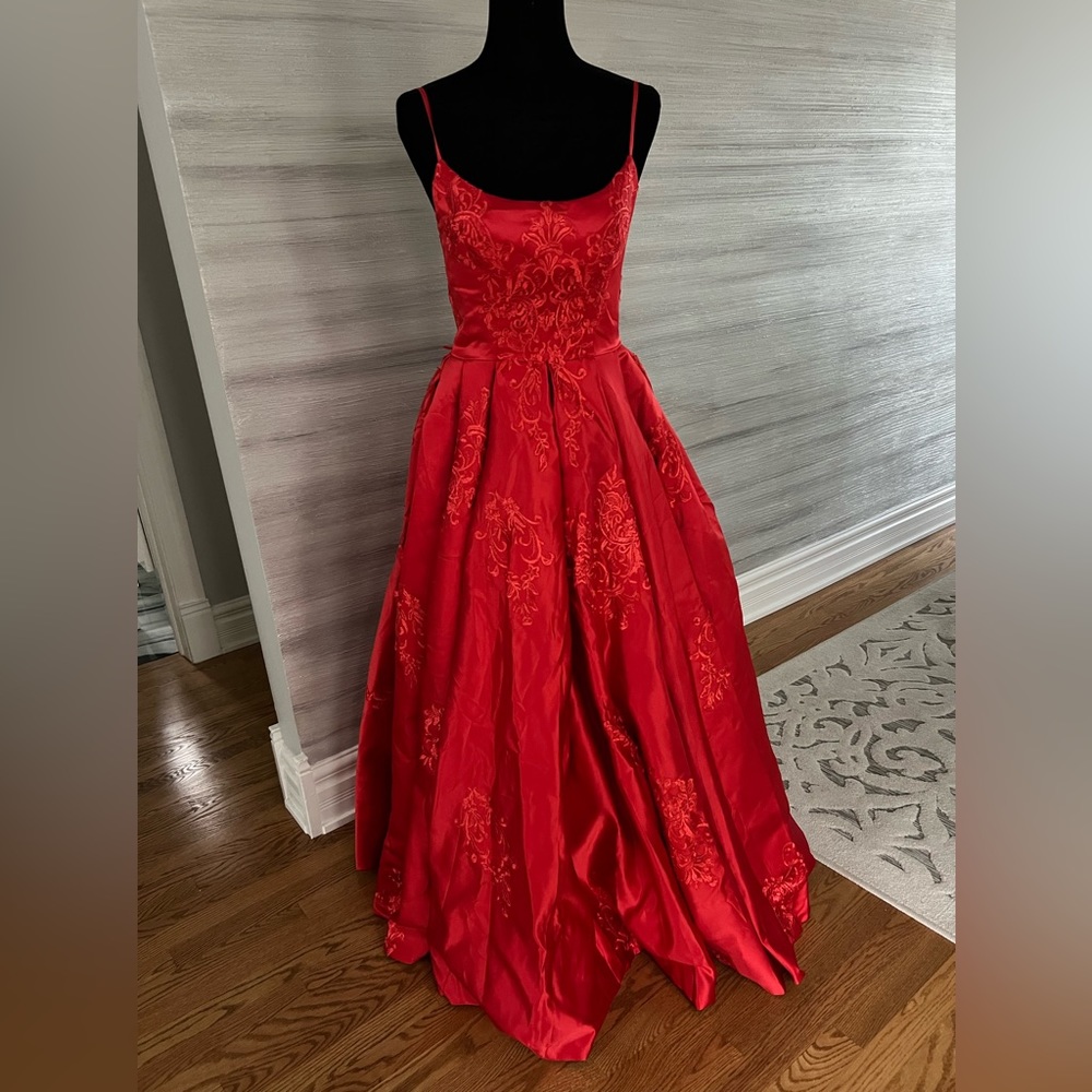 Red gown with red embroidery, with lace up tying in the back